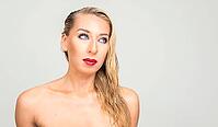 Studio shot of young beautiful blonde woman shirtless as health and beauty concept against white background [IBR124308995]
