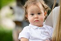 Portrait of young adorable baby boy with curly blond hair [IBR124309011]