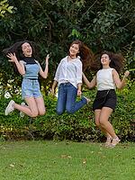 Portrait of three young Asian women as friends together relaxing at the park outdoors [IBR124309016]