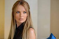 Portrait of young beautiful businesswoman with blond hair indoors [IBR124309022]