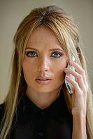 Portrait of young beautiful businesswoman with blond hair indoors [IBR124309023]