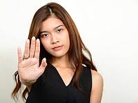 Studio shot of young beautiful Asian woman against white background [IBR124309028]