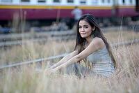 Portrait of young beautiful Asian woman at the railway station [IBR124309030]