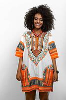 Studio shot of young beautiful African woman with Afro hair wearing traditional clothes against white background [IBR124309039]