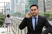 Portrait of young handsome Indian businessman in the city [IBR124309042]