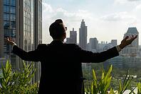 Portrait of handsome bearded Hispanic businessman with nature in the city outdoors [IBR124309047]
