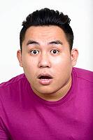 Studio shot of young handsome overweight Filipino man against white background [IBR124309055]
