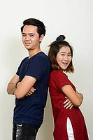 Studio shot of young Asian man and young Asian woman together against white background [IBR124309062]