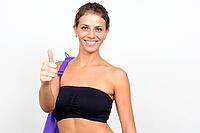 Studio shot of young beautiful woman with curly hair ready for gym against white background [IBR124309064]