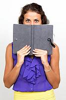 Studio shot of young beautiful businesswoman with curly hair against white background [IBR124309071]