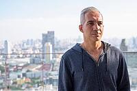 Portrait of handsome Persian man with gray hair against view of the city [IBR124309086]