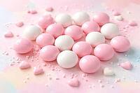 Pink and white candy balls on a pastel background with heart decoration, pastel candy, AI generated [IBR124458830]