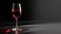 A wine glass filled with red wine in a dark minimalistic setting, AI generates, AI generated [IBR124458847]