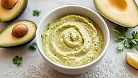 Creamy avocado dip in a white bowl surrounded by avocados and herbs, delicious dip, perfect as a side dish for meals and parties, AI generates, AI generated [IBR124458860]