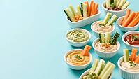 Various dips in bowls with fresh vegetables on a blue background, delicious dip, perfect as a side dish for meals and parties, AI generated [IBR124458864]