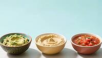 Three different dips in bowls: avocado, hummus and salsa, on a light background, delicious dip, perfect as a side dish for meals and parties, AI generates, AI generated [IBR124458885]