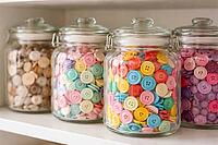 Multicolor buttons in glass containers, stylishly arranged on a shelf, DIY material, neatly sorted, storage and organization system for hobbies and creative craft projects, AI generated [IBR124458893]