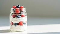 A glass with yogurt and berries, simple design, strong natural light, delicious dessert, beautifully presented, AI generated [IBR124458903]