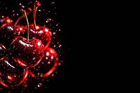 Bright red cherries with drops of water in a dark environment, healthy food, AI generated [IBR124458915]