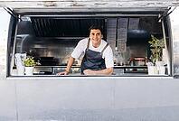 Portrait of a young food truck owner. Food truck owner waiting for customers [IBR124491545]