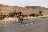 Road bike female cyclist riding on pro bike outdoors. ?Woman practicing on bicycle on empty road [IBR124491557]