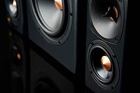 Two sound speakers and subwoofer on dark background. Set for listening music. Audio equipment [IBR124497431]
