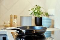 Steel frying pan in the kitchen on electric induction hob, Modern kitchen appliance [IBR124497441]