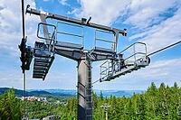 Open cable car line. Metal cable and moving rollers on platform for funicular mechanism, close up. Karpacz resort in Poland with lift road [IBR124497450]
