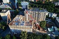 Aerial view of construction site with residential building under construction. Tower crane on construction site in city [IBR124497453]
