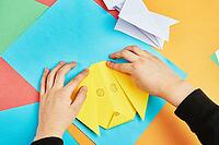 Boy hands making origami dog with colorful paper sheets, Child creative education [IBR124497459]