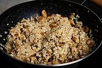 Process of cooking risotto. Arborio rice in frying pan at home kitchen. Italian cuisine dish [IBR124497477]