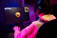 Teenager boy play computer video game in dark room, use neon colored rgb mechanical keyboard, workplace for cybersport gaming, children gaming addiction [IBR124497484]