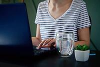 Caucasian woman typing with laptop keyboard at home office workplace. Freelancer remotely working [IBR124497487]