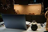 Laptop on table at living room in the night. Home office workpalce with laptop. Overworking and night working concept [IBR124497493]