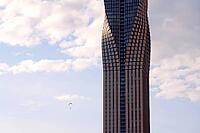 Paraglider with the tallest building in Scandinavia Karlatornet skycraper in Lindholmen, Gothenburg, Sweden, sunny day [IBR124525448]