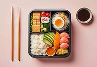 A top-down view of a meticulously arranged bento box showcasing a variety of Japanese delicacies including sushi rolls, steamed rice, fresh salmon slices, and a perfectly cooked egg, AI generated [IBR124550805]