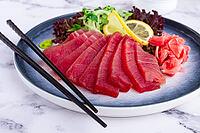 Tuna sashimi, with side dish, on a marble table, homemade, no people [IBR124552171]