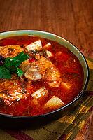 Souzi soup. Georgian dish, meat with oats, tomato sauce and herbs, on a wooden table [IBR124552182]