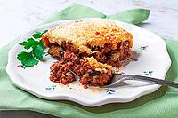 Sliced moussaka, Greek dish, baked eggplant with minced meat, with bechamel sauce, home cooking [IBR124552195]