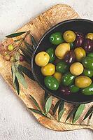 A mixture of olives, varieties of chalkidiki, Verdi giganti and Kalamata, in a bowl, top view, no people [IBR124552199]
