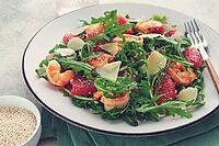 Fresh shrimp salad with arugula, grapefruit, and parmesan served in a bowl [IBR124552212]