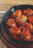 Minced meat meatballs, in tomato sauce, in a cast-iron pan, homemade, no people [IBR124552229]