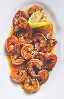 Fried tiger prawns, jumbo, in garlic sauce, in butter, with herbs, on a white plate, homemade, no people [IBR124552230]