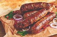 Fried kupaty on parchment, with red onion and pomegranate, kupaty, Georgian cuisine [IBR124552240]