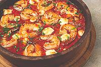 Saganaki with shrimp, in a clay pan, Greek dish, shrimp in tomato sauce, feta cheese, homemade, no people [IBR124552259]