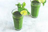 Two glasses, with green smoothie, celery and spinach, apple and kiwi, cucumber, vegetable smoothie, breakfast, homemade, no people [IBR124552261]