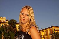 Pretty blonde girl in the old town of Lazise, Garda Lake, Italy - Nice blond girl in the old town of Lazise, Lake Garda, Italy [IBR124585321]