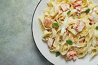 Tagliatelle pasta, in cream sauce with salmon, homemade, no people [IBR124585336]