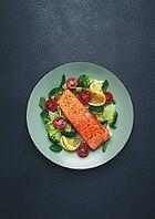 Grilled salmon fillet, with vegetables, broccoli, cherry, iceberg lettuce, spices and herbs, homemade, no people [IBR124585355]