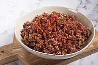 Raw minced meat, marinated with spices and herbs, in a bowl, minced meat with spices, top view, homemade, no people [IBR124585356]